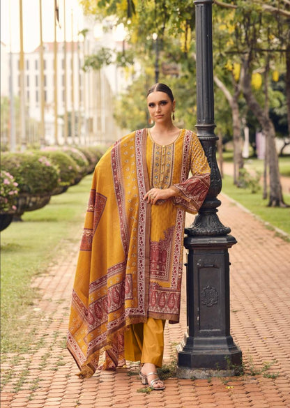 Woman in a yellow and red traditional outfit standing next to a black lamp post in a park.